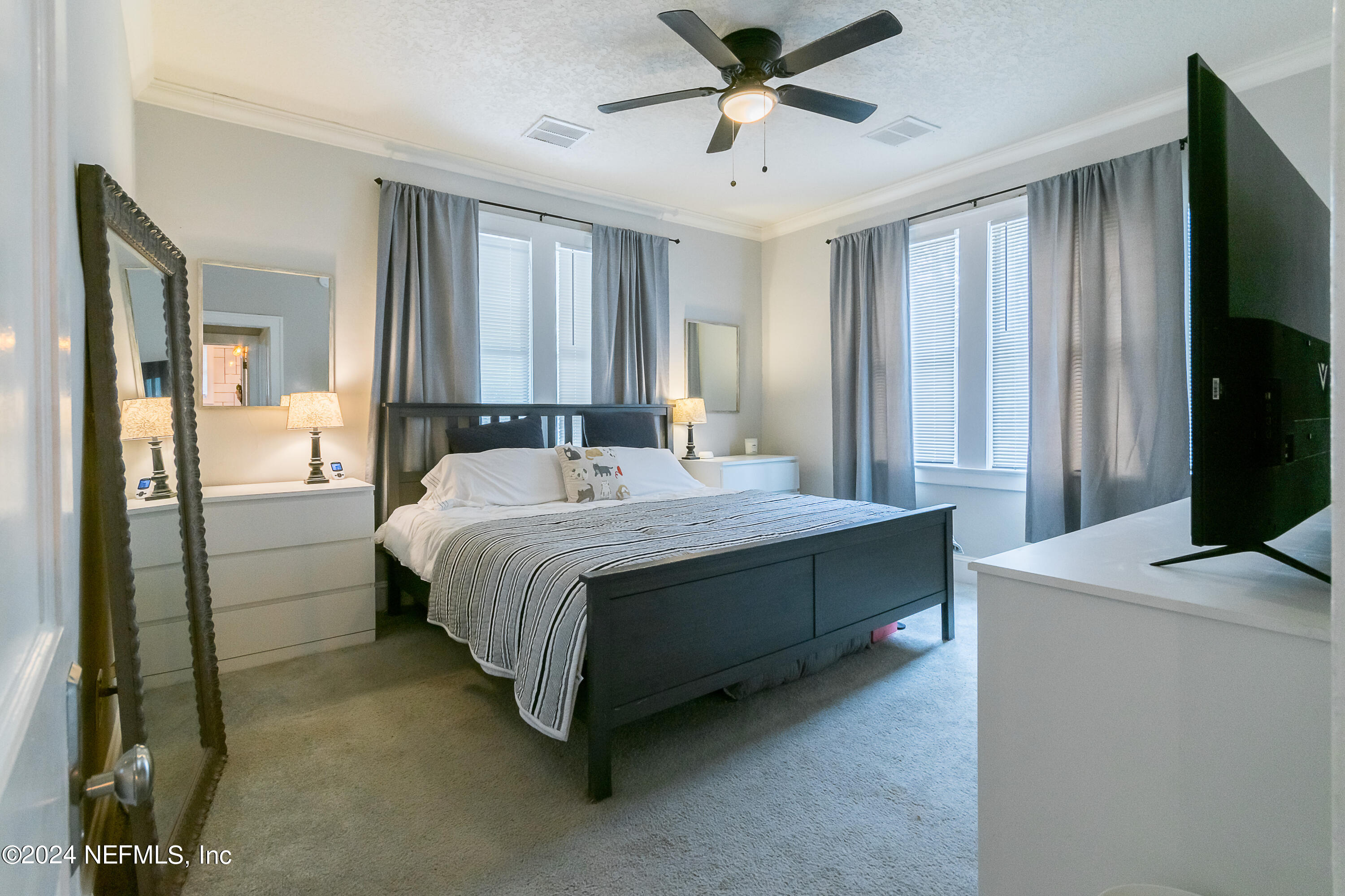 1262 Murray Drive Jacksonville, FL 32205 - Photo 22 of 42 a bedroom with a bed and a chandelier