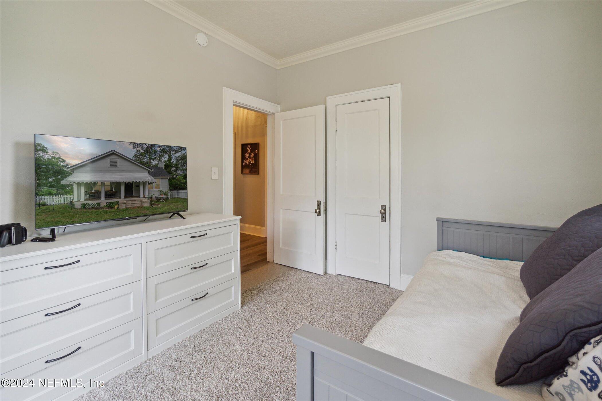 1262 Murray Drive Jacksonville, FL 32205 - Photo 25 of 42 a bedroom with a bed and a mirror on dresser