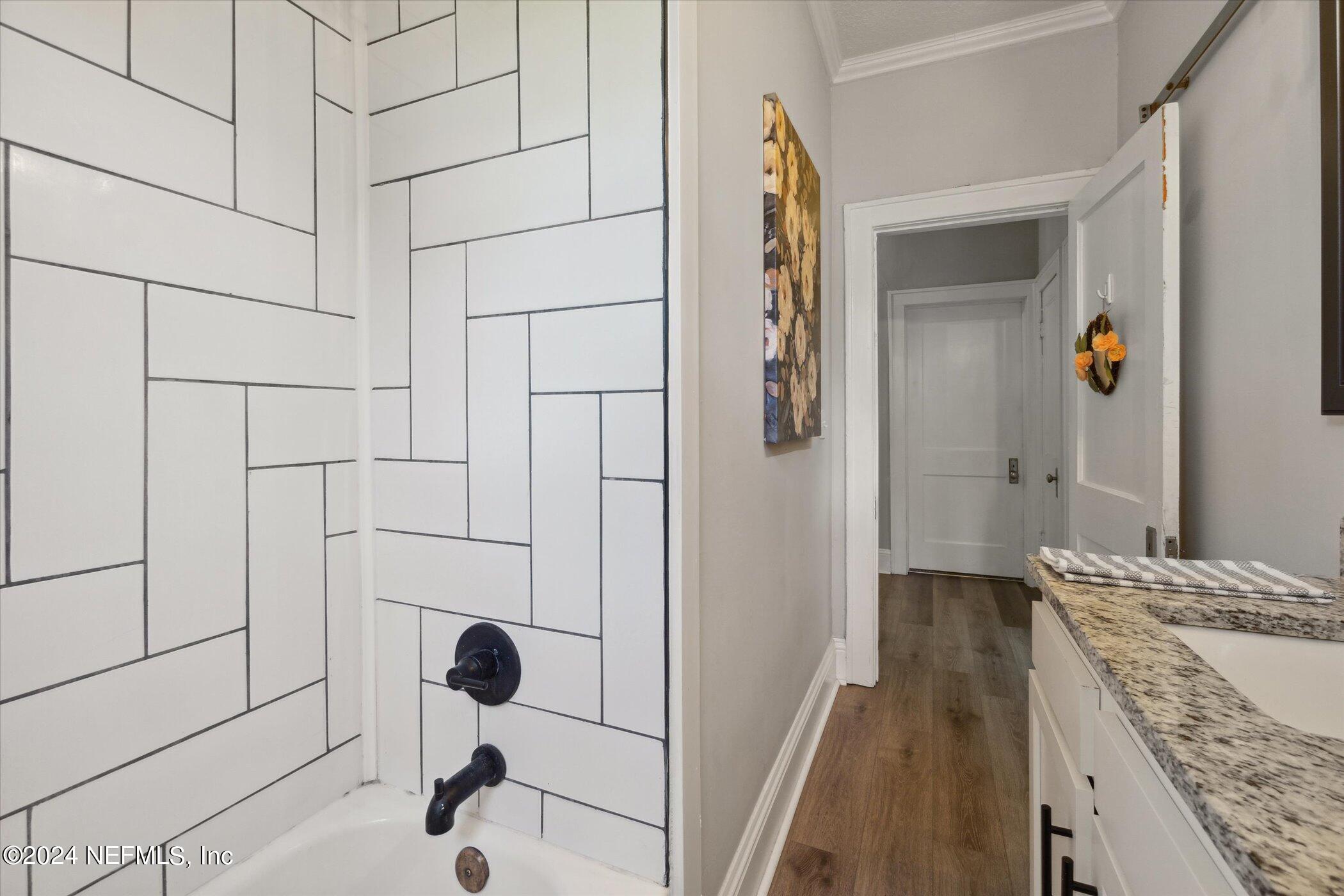 1262 Murray Drive Jacksonville, FL 32205 - Photo 29 of 42 a bathroom with a granite countertop sink a mirror and shower