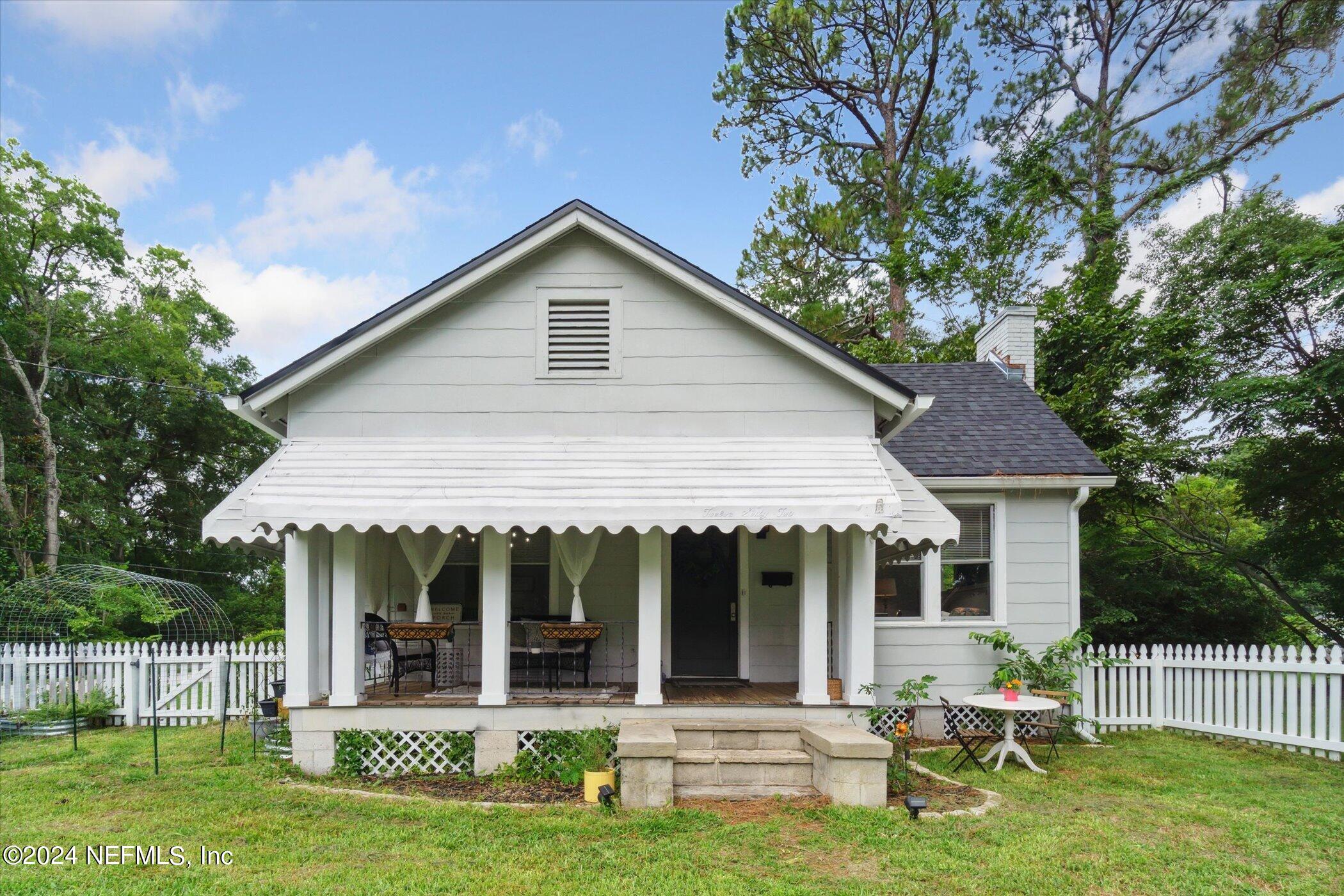 1262 Murray Drive Jacksonville, FL 32205 - Photo 3 of 42 a front view of a house with a yard table and chairs