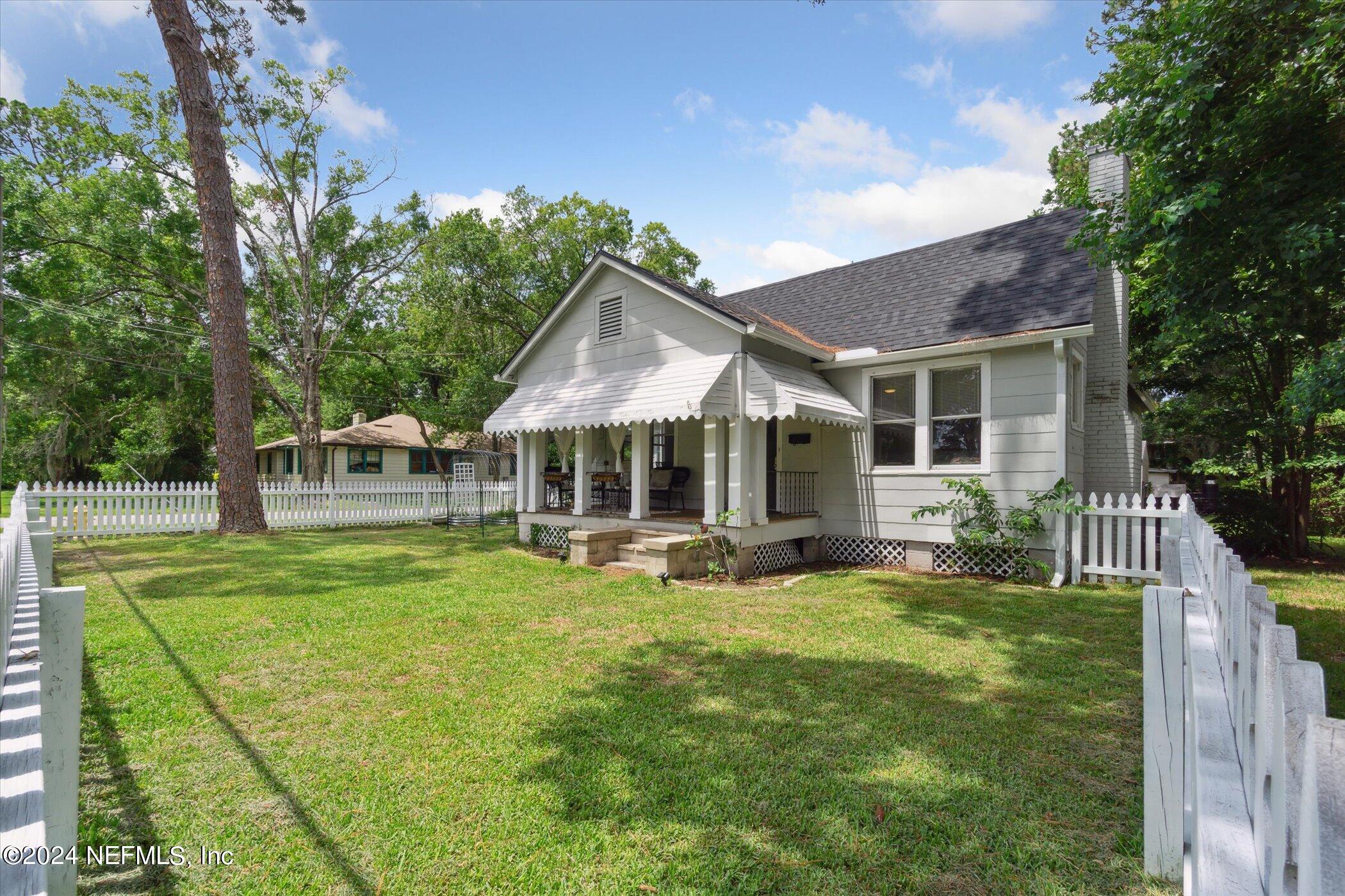 1262 Murray Drive Jacksonville, FL 32205 - Photo 39 of 42 a patio with a table and chairs and a big yard