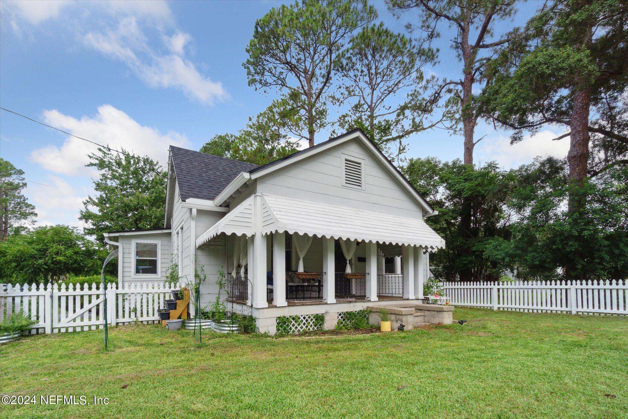 1262 Murray Drive Jacksonville, FL 32205 - Photo 4 of 42 a front view of a house with a yard table and chairs