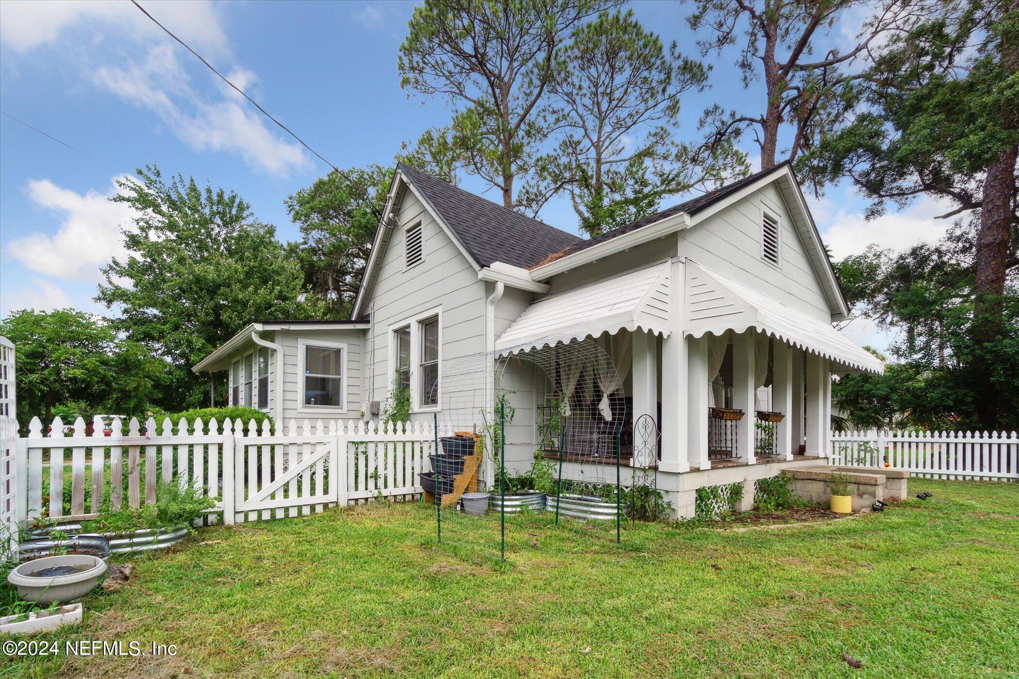 1262 Murray Drive Jacksonville, FL 32205 - Photo 41 of 42 a view of a house with a yard deck and a large tree