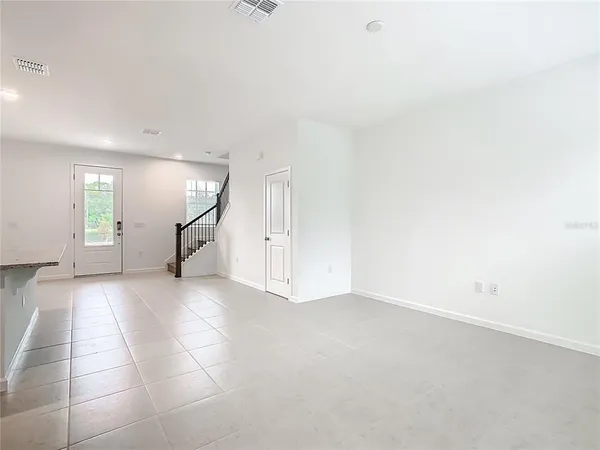 an empty room with windows and closet