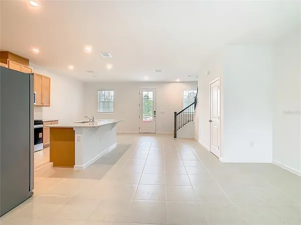 a view of a kitchen with a refrigerator and a sink