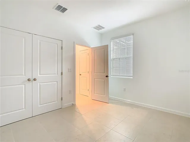 a view of an empty room with closet area