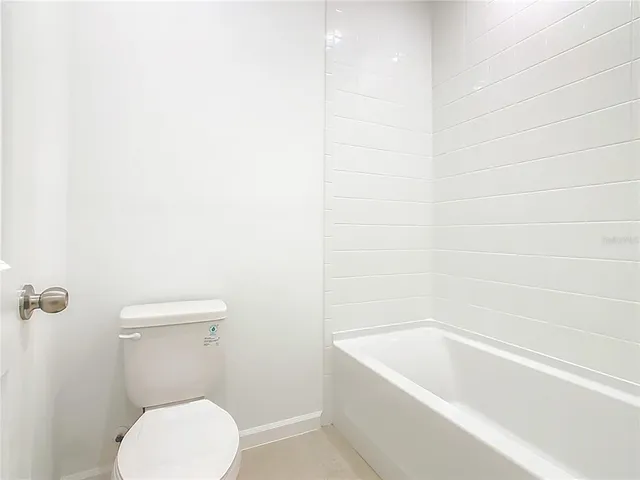 an empty room with white wall