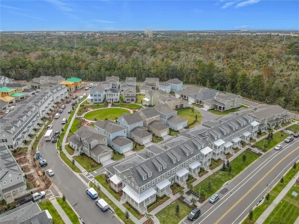 a view of an empty room with stairs and a window