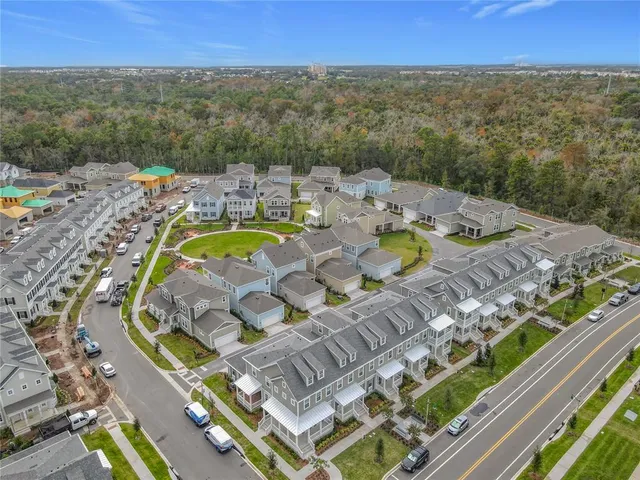 a view of an empty room with stairs and a window