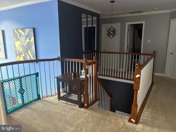 a view of staircase with railing and a window