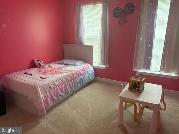 a bedroom with a bed and a table in it
