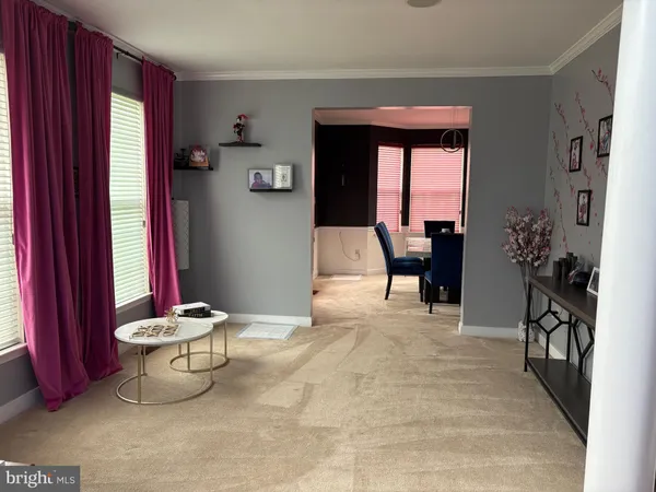 a living room with furniture and potted plant