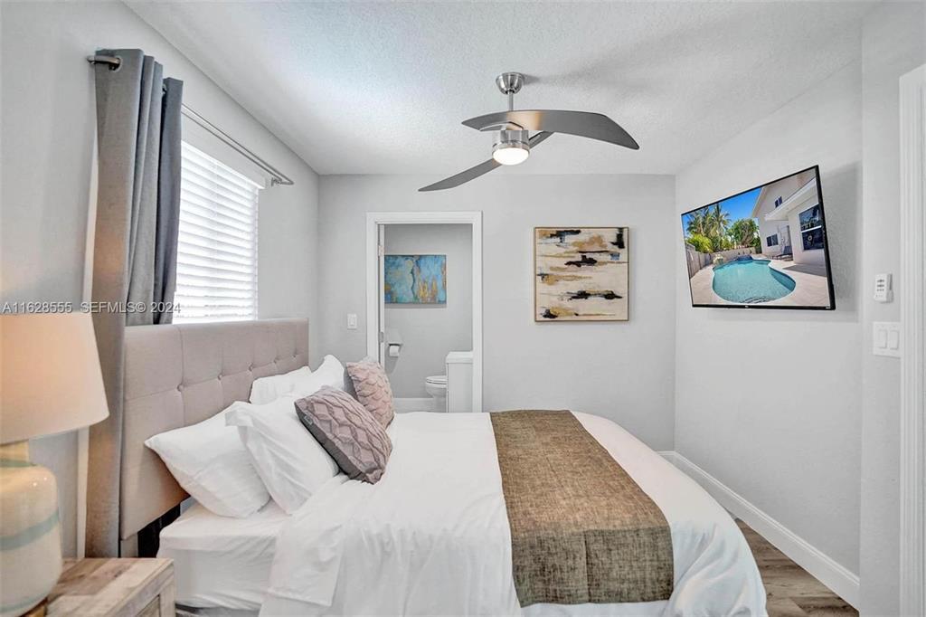 3421 Dover Road Pompano Beach, FL 33062 - Photo 16 of 22 a bedroom with a bed and wooden floor