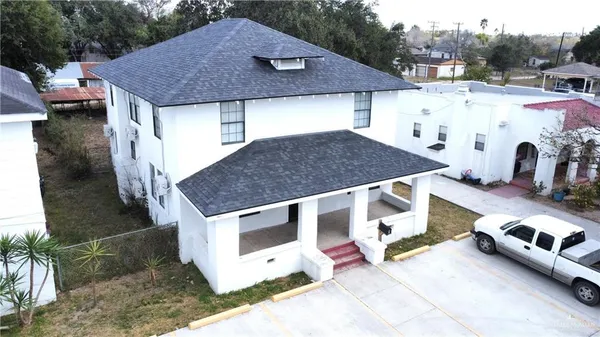 a aerial view of a house with a yard and balcony