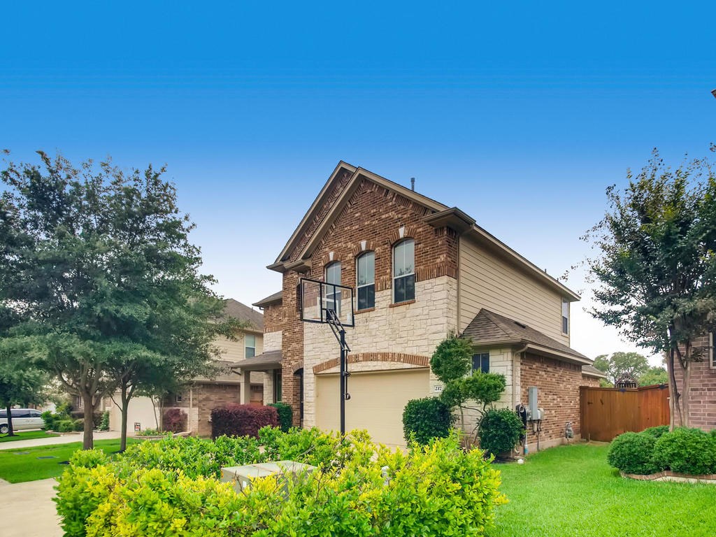 217 Fort Mabry Loop Georgetown, TX 78628 - Photo 1 of 1 a front view of a house with garden