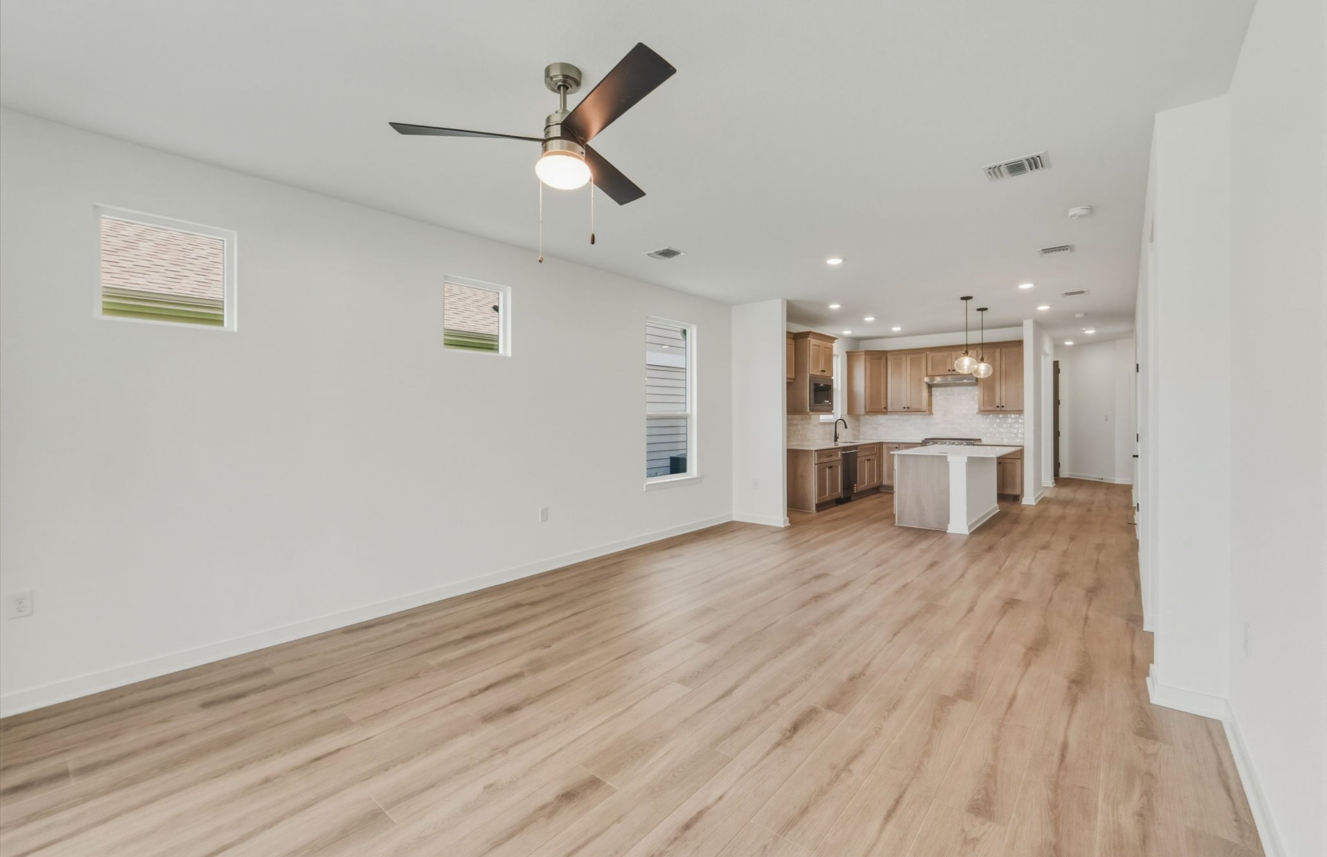 207 Smokestack Lane Georgetown, TX 78633 - Photo 5 of 21 a view of a kitchen with a fridge and wooden floor