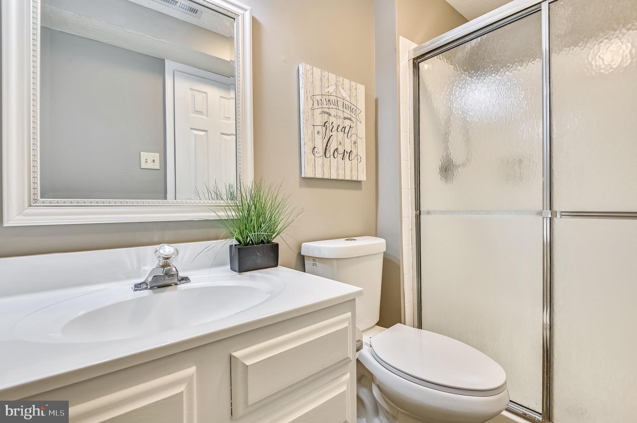 2240 Riding Crop Way Baltimore, MD 21244 - Photo 27 of 38 a bathroom with a sink a toilet and shower