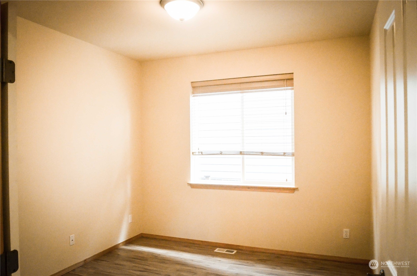 5139 Northeast 8th Place Renton, WA 98059 - Photo 17 of 33 a view of a small space with wooden floor and a window