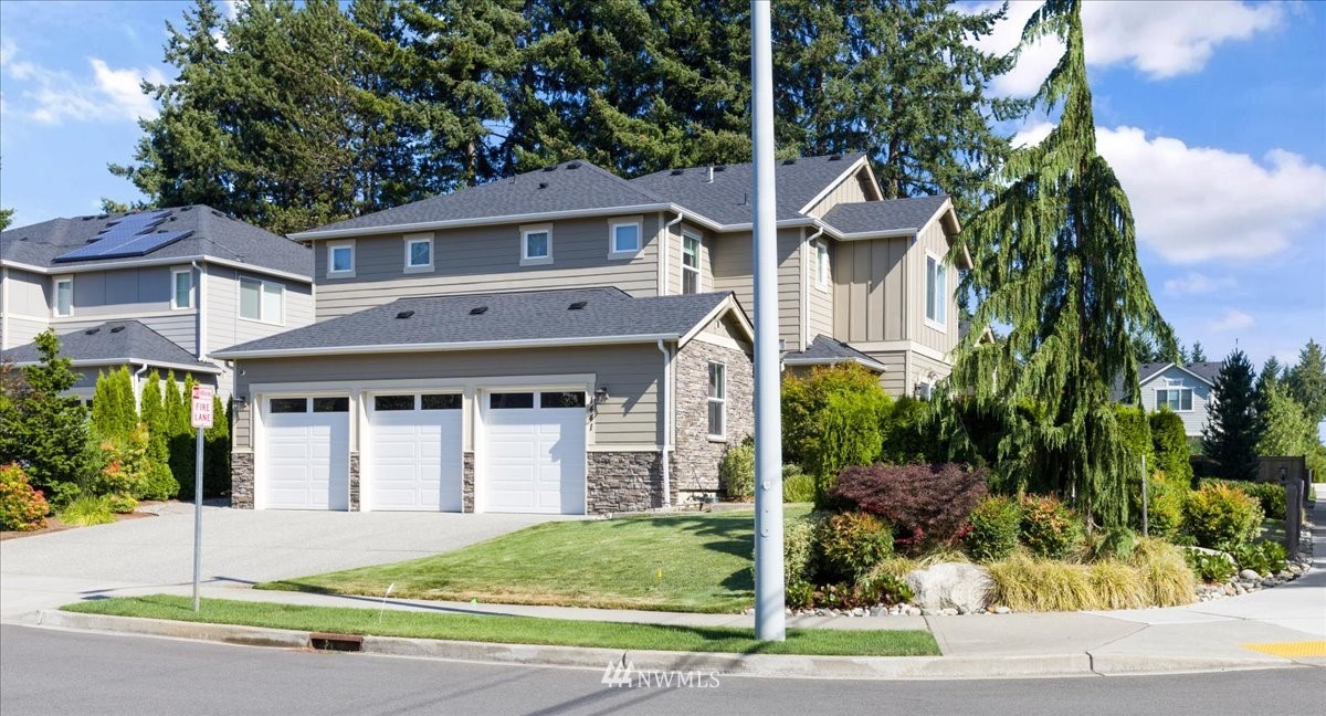 1441 242nd Place Southeast Bothell, WA 98021 - Photo 2 of 40 a front view of a house with a garden and plants