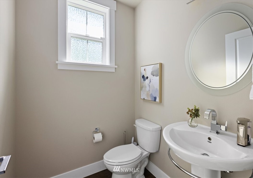 1441 242nd Place Southeast Bothell, WA 98021 - Photo 22 of 40 a white toilet sitting next to a bathroom sink