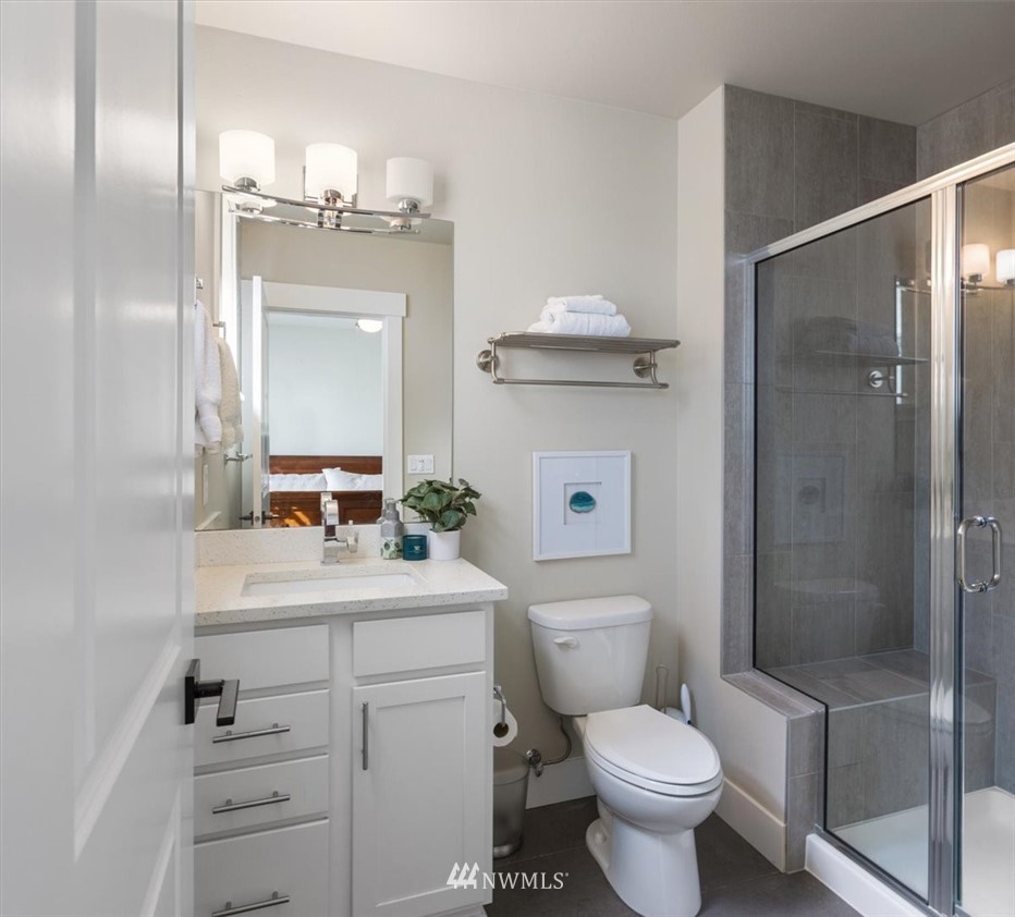 1441 242nd Place Southeast Bothell, WA 98021 - Photo 23 of 40 a bathroom with a sink a toilet and shower