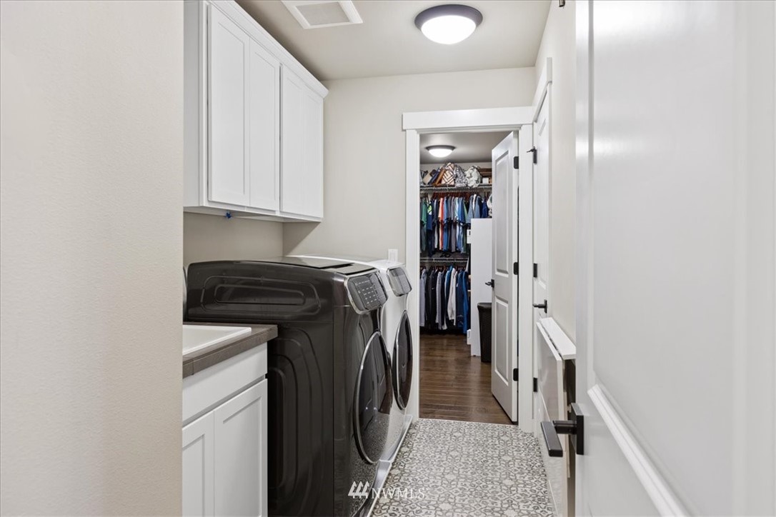 1441 242nd Place Southeast Bothell, WA 98021 - Photo 25 of 40 a view of walk in closet with clothes and shoes