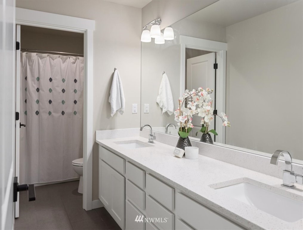1441 242nd Place Southeast Bothell, WA 98021 - Photo 28 of 40 a bathroom with a double vanity sink toilet and shower