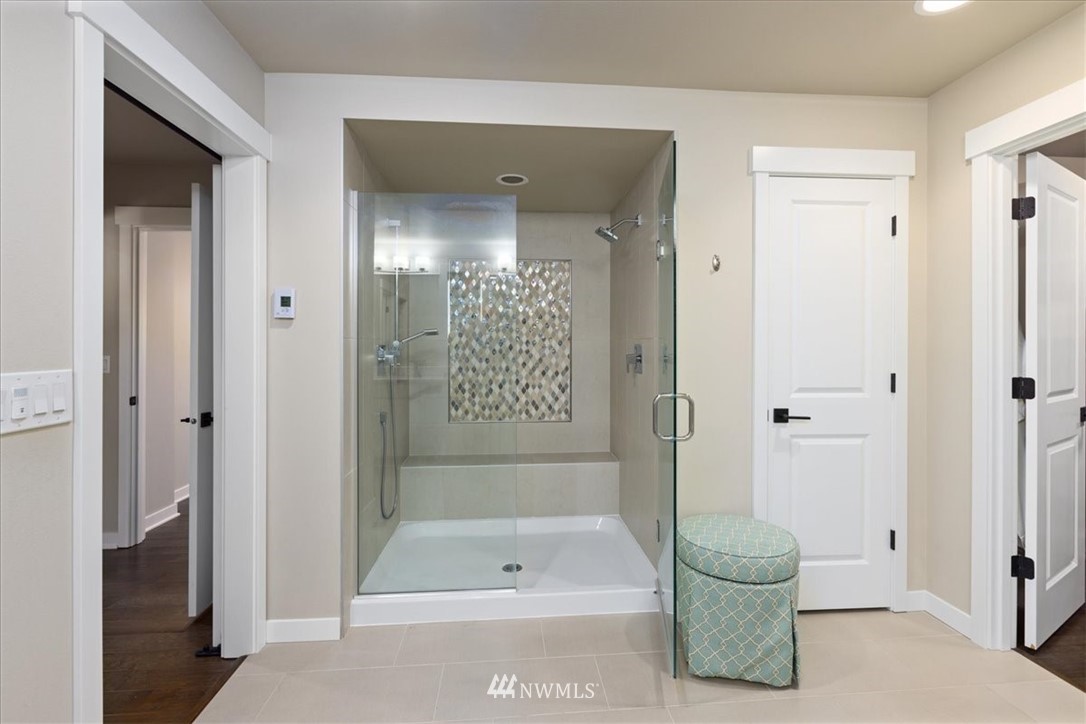1441 242nd Place Southeast Bothell, WA 98021 - Photo 29 of 40 a bathroom with a tub and shower