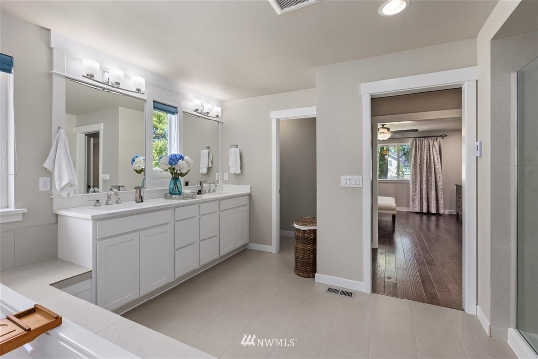 1441 242nd Place Southeast Bothell, WA 98021 - Photo 34 of 40 a bathroom with a double vanity sink mirror and shower