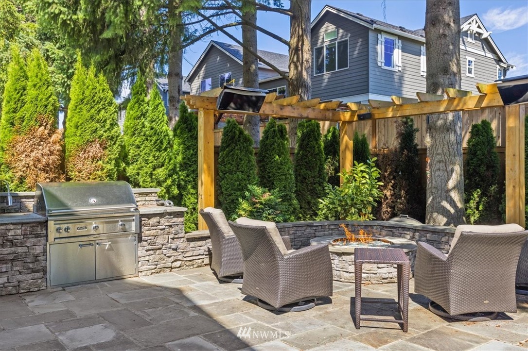 1441 242nd Place Southeast Bothell, WA 98021 - Photo 40 of 40 a view of a patio with table and chairs and potted plants