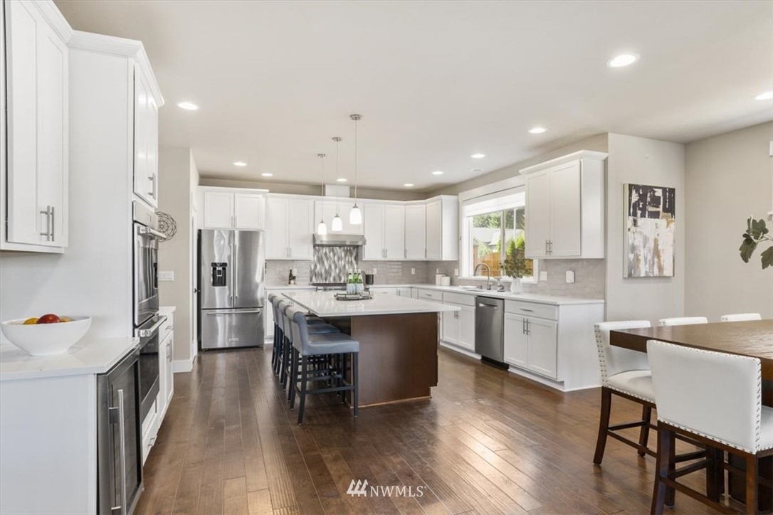 1441 242nd Place Southeast Bothell, WA 98021 - Photo 10 of 40 a large kitchen with a table and chairs in it