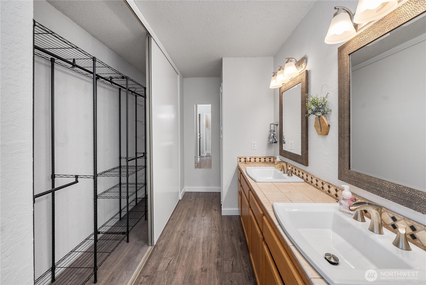 14401 Southeast Petrovitsky Road, Unit G204 Renton, WA 98058 - Photo 16 of 29 a bathroom with a double vanity sink and mirror