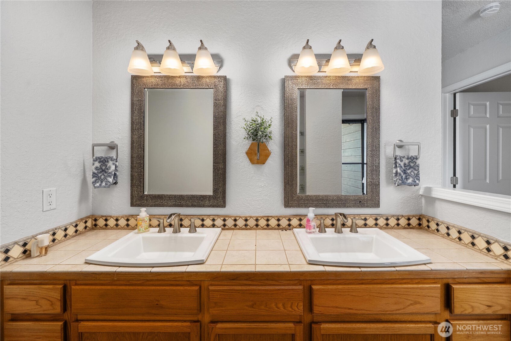 14401 Southeast Petrovitsky Road, Unit G204 Renton, WA 98058 - Photo 17 of 29 a bathroom with a sink and a mirror