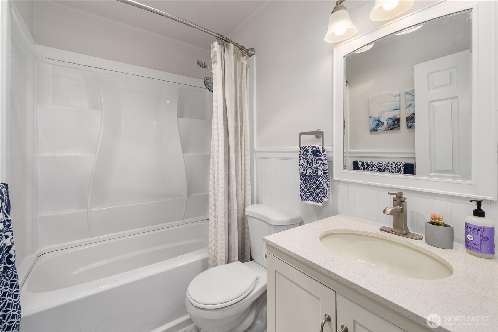 14401 Southeast Petrovitsky Road, Unit G204 Renton, WA 98058 - Photo 20 of 29 a bathroom with a granite countertop sink toilet and shower