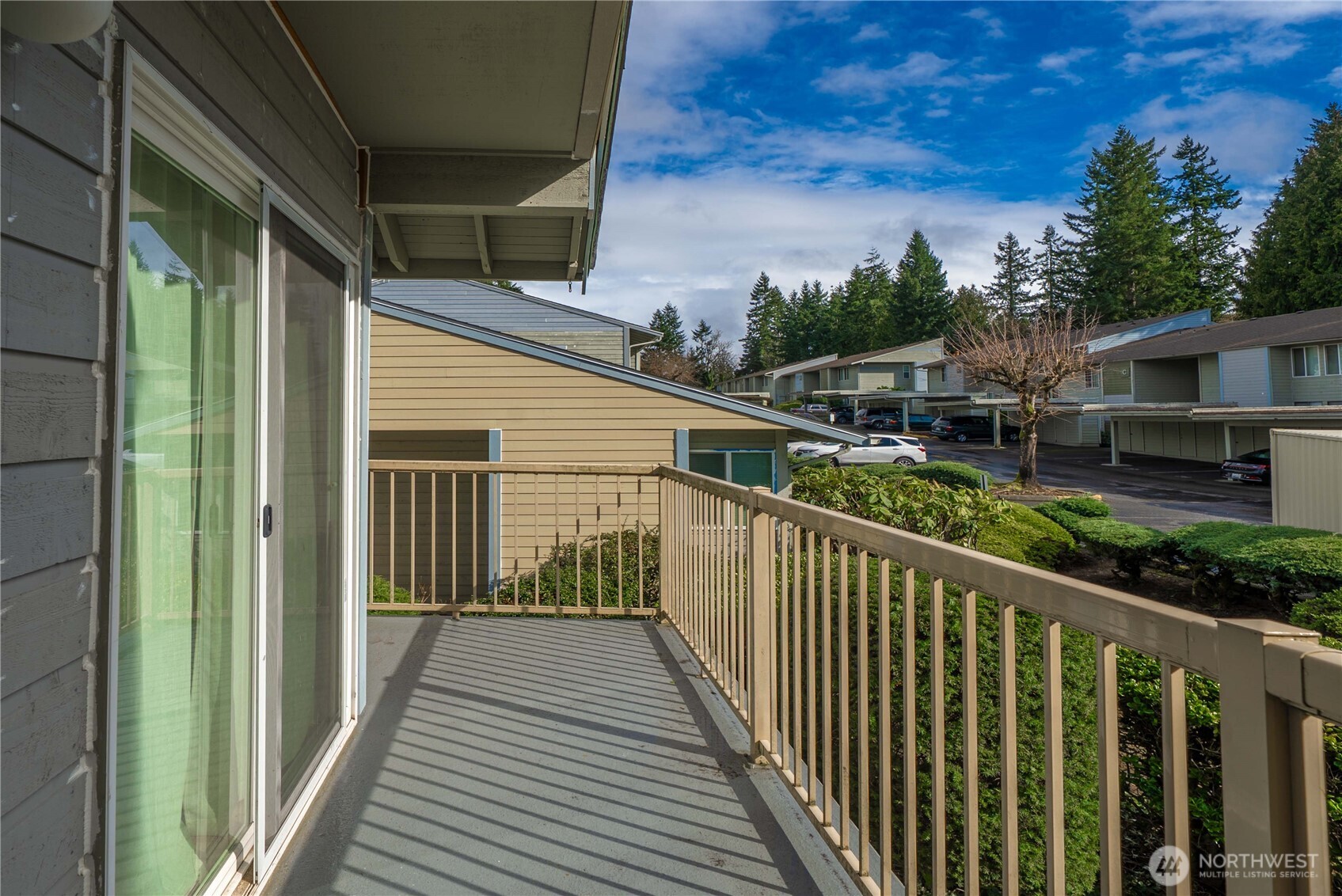 14401 Southeast Petrovitsky Road, Unit G204 Renton, WA 98058 - Photo 22 of 29 a view of a balcony with wooden floor