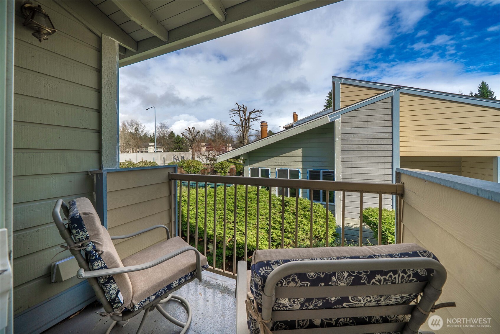 14401 Southeast Petrovitsky Road, Unit G204 Renton, WA 98058 - Photo 23 of 29 a view of a chair and tables in the balcony