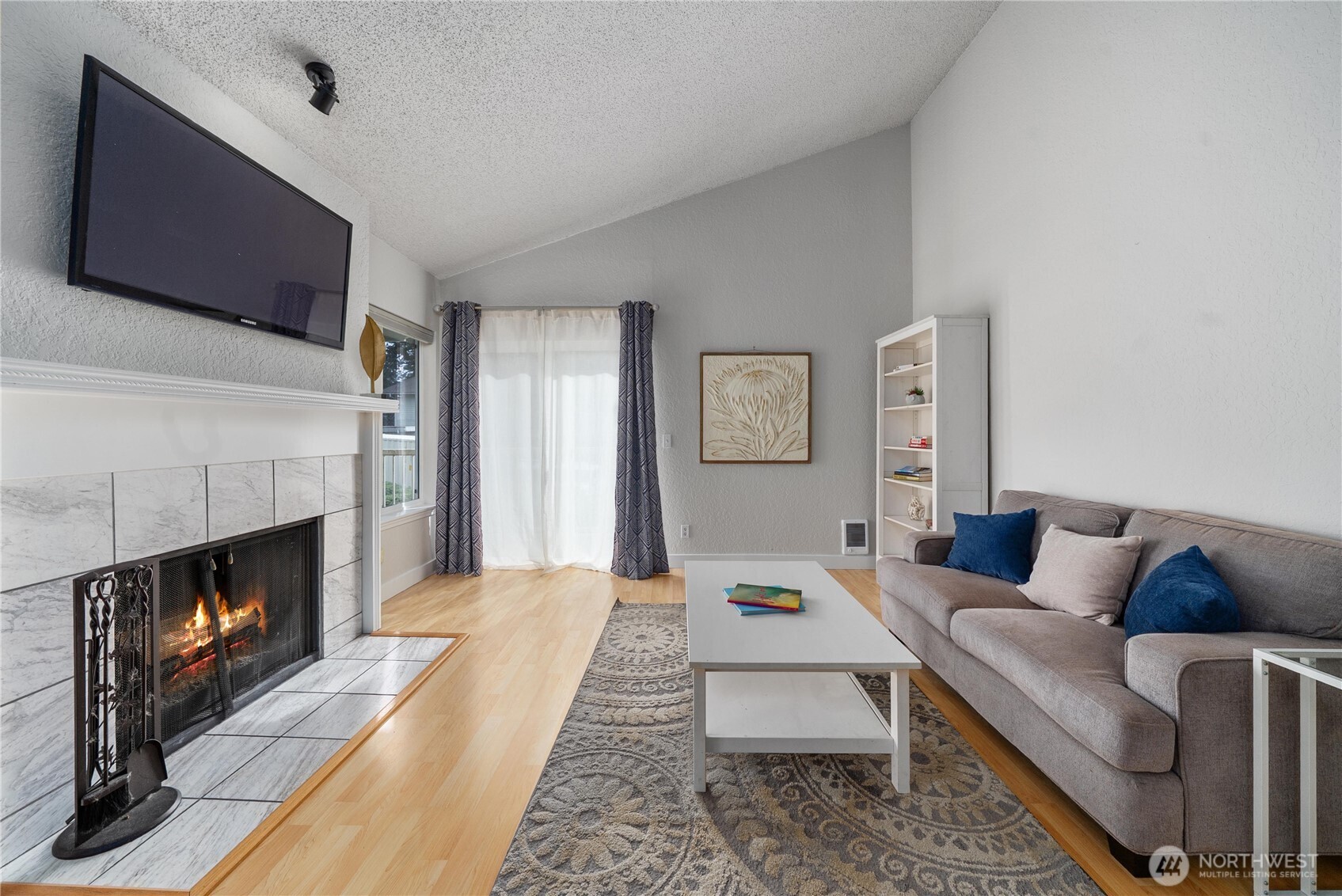 14401 Southeast Petrovitsky Road, Unit G204 Renton, WA 98058 - Photo 4 of 29 a living room with furniture and a fireplace