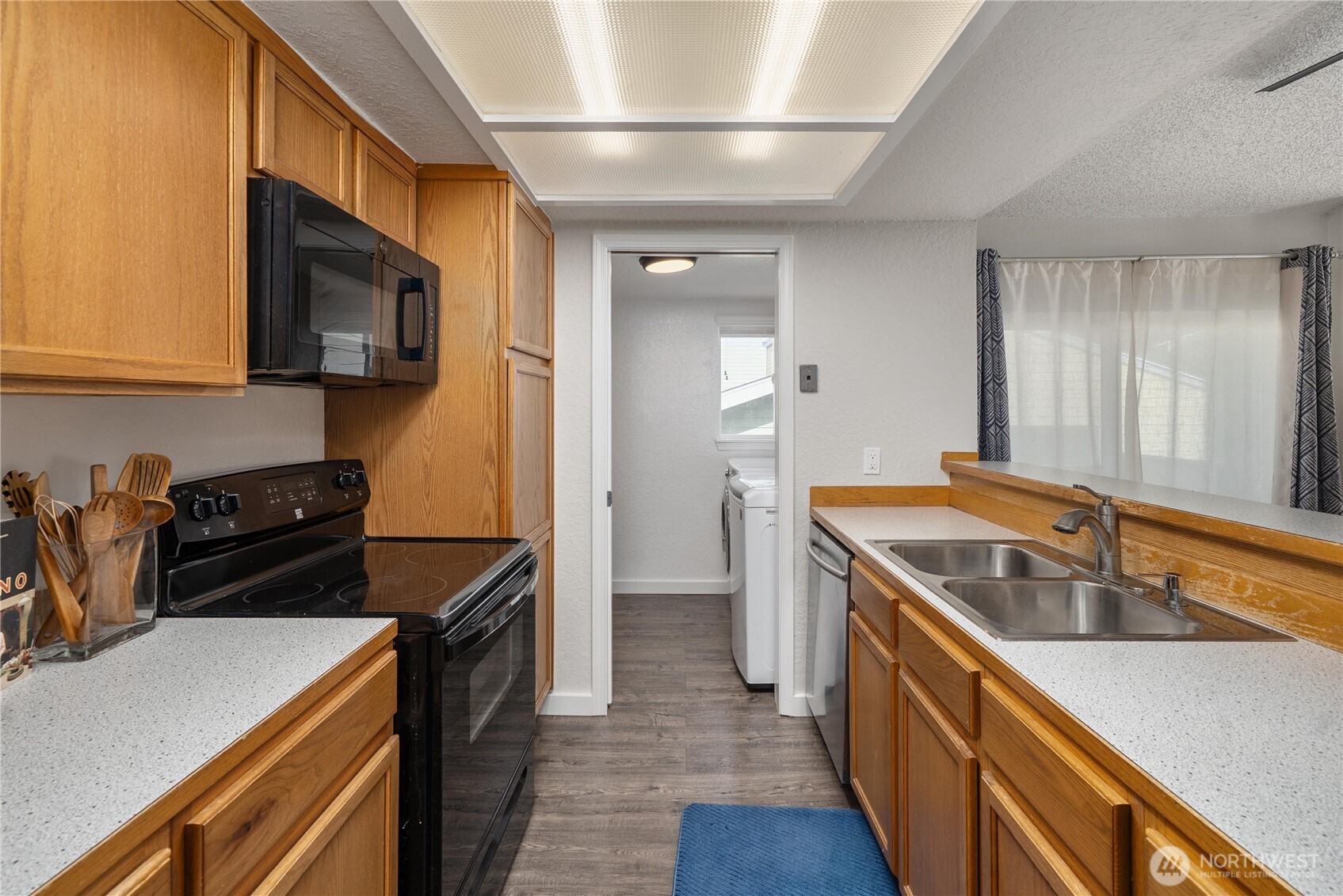 14401 Southeast Petrovitsky Road, Unit G204 Renton, WA 98058 - Photo 8 of 29 a kitchen that has a sink and a stove