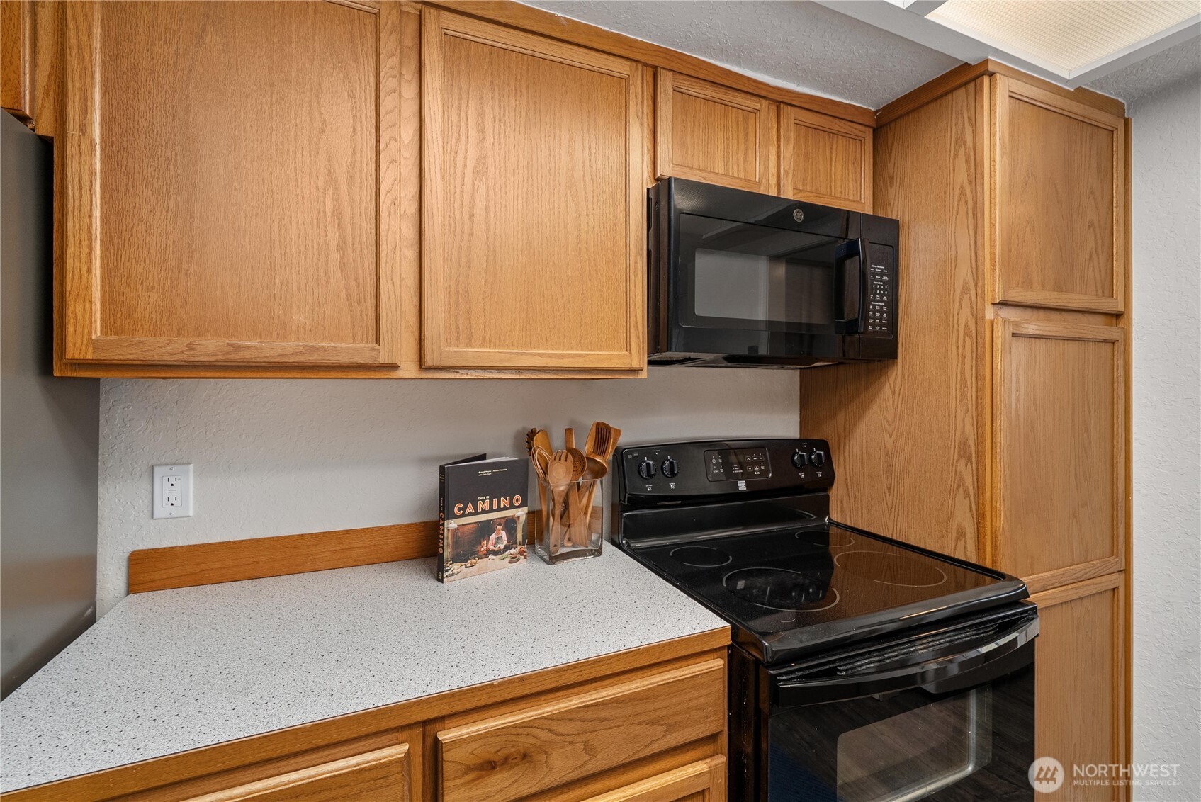 14401 Southeast Petrovitsky Road, Unit G204 Renton, WA 98058 - Photo 9 of 29 a kitchen with a stove and a microwave