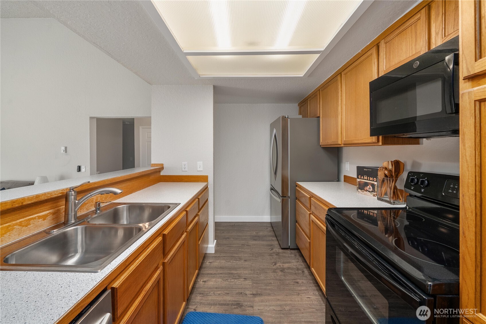 14401 Southeast Petrovitsky Road, Unit G204 Renton, WA 98058 - Photo 10 of 29 a kitchen with stainless steel appliances granite countertop a sink and a stove