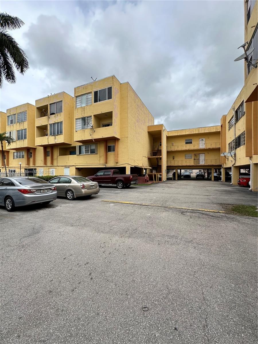 1555 West 44th Place, Unit 234 Hialeah, FL 33012 - Photo 1 of 36 a car parked in front of a building