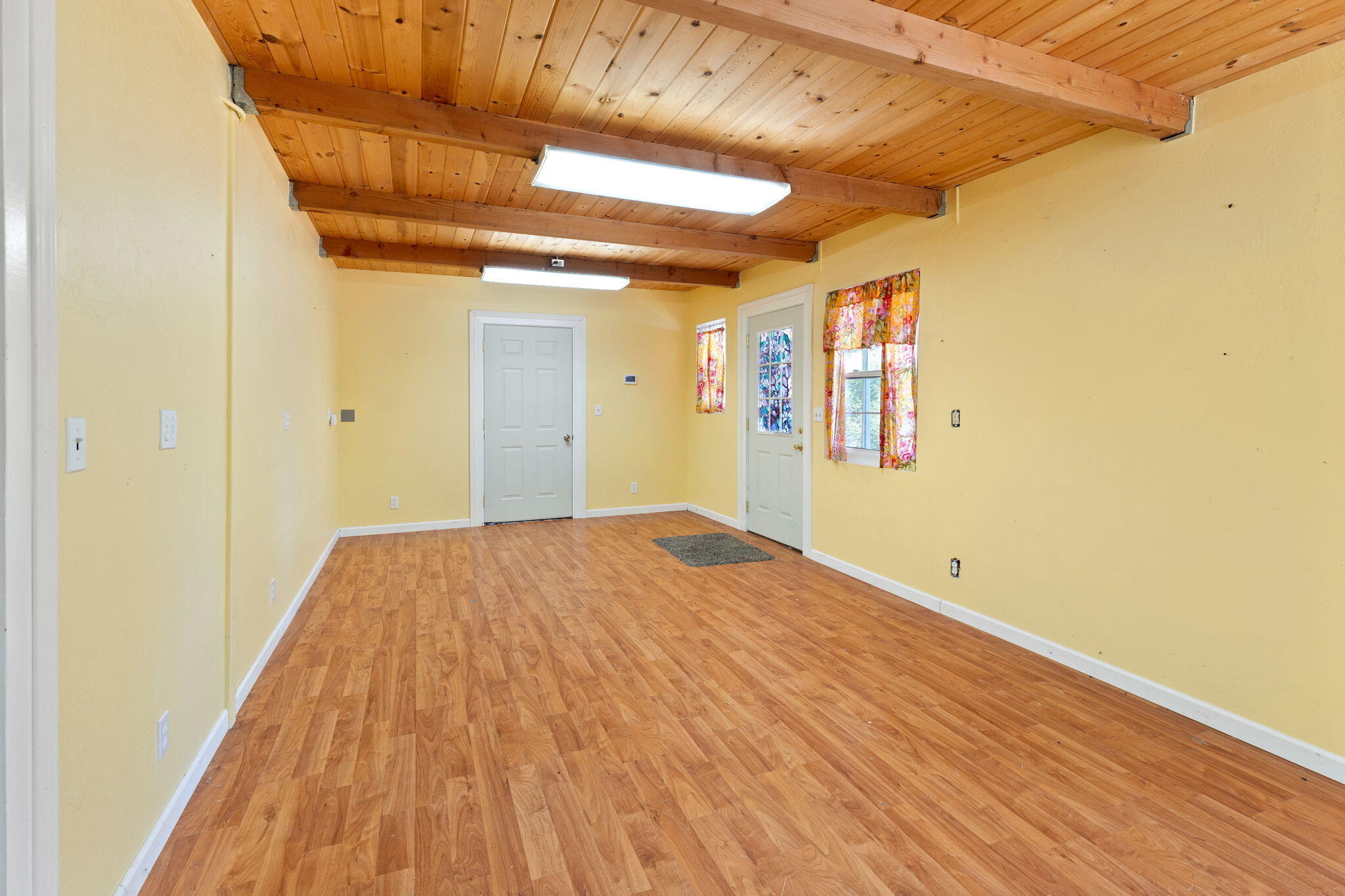 7304 North Applegate Road Grants Pass, OR 97527 - Photo 56 of 87 a view of a room with wooden floor and a ceiling fan