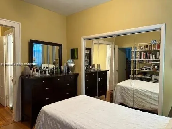 a bedroom with a bed and a dresser