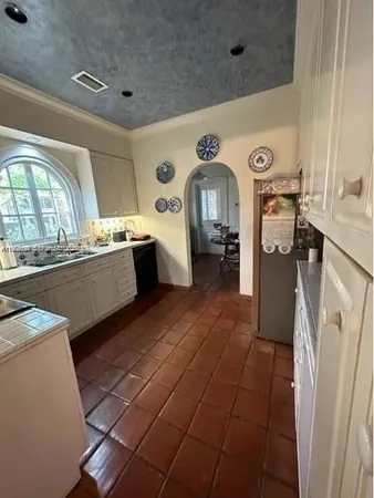 a kitchen with a sink appliances and cabinets