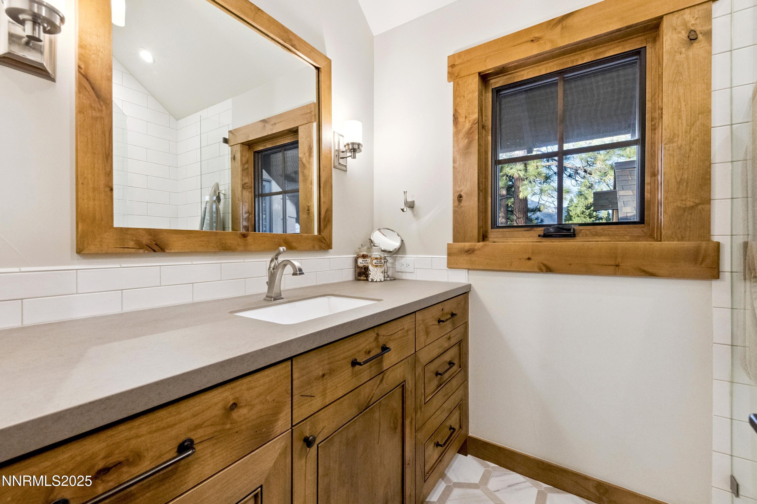 261 Redding Way Carson City, NV 89705 - Photo 42 of 90 a bathroom with a sink and a mirror