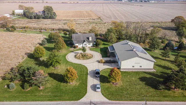 a aerial view of a house with backyard outdoor seating and mountain view