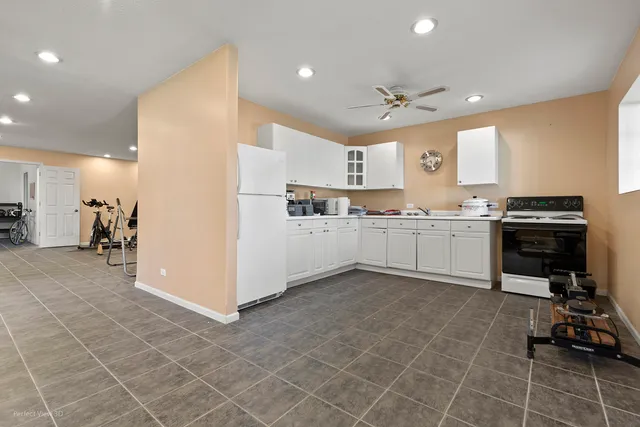 a kitchen with a sink a cabinets and appliances