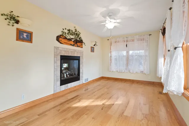 a view of an empty room with a fireplace