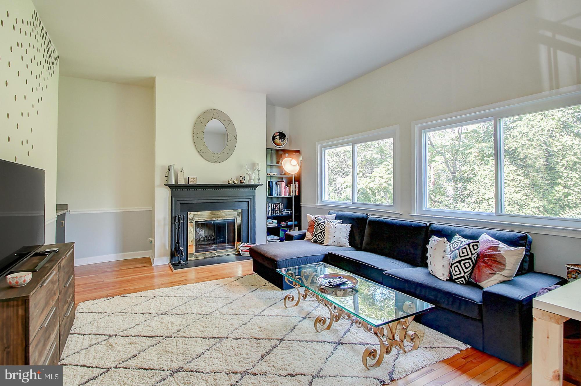 7222 Brookfalls Terrace Baltimore, MD 21209 - Photo 2 of 29 a living room with furniture a fireplace and a large window