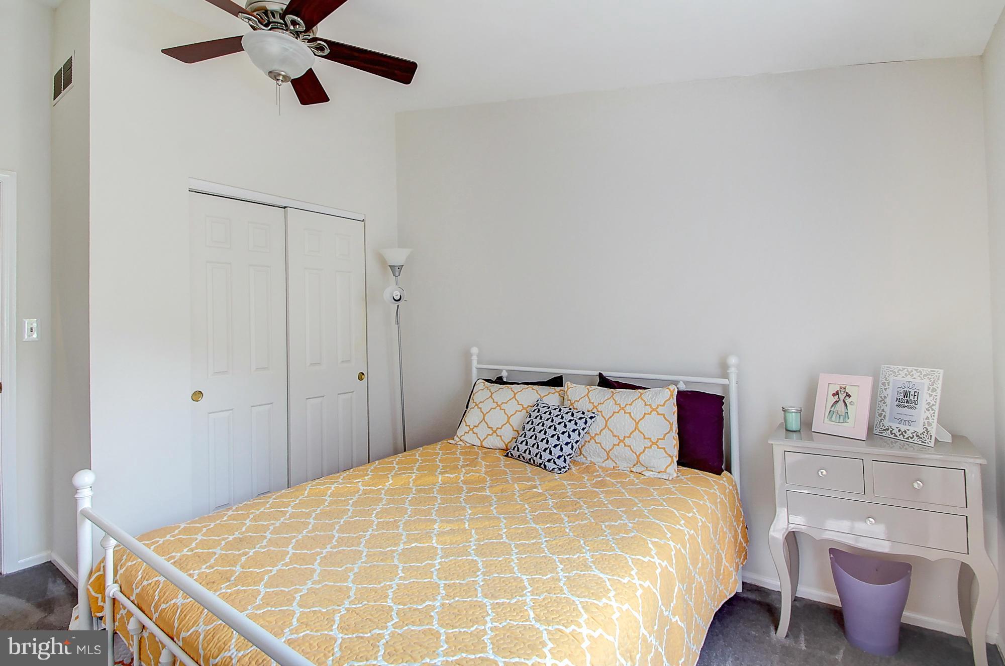 7222 Brookfalls Terrace Baltimore, MD 21209 - Photo 22 of 29 a bedroom with a bed and a chandelier